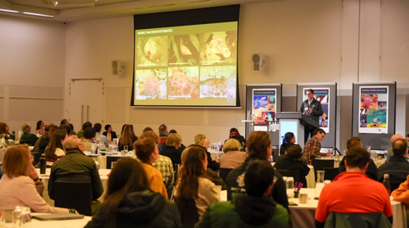 Photograph of attendees at the Port Phillip Bay forum facing a speaker presenting. 