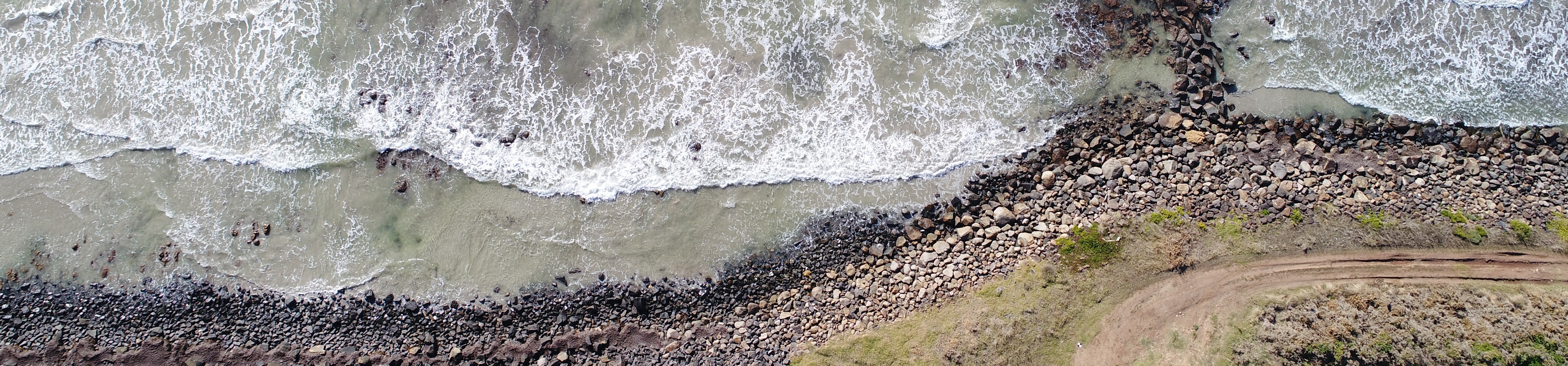 Drone photo of waves crashing onto Dutton Way Beach