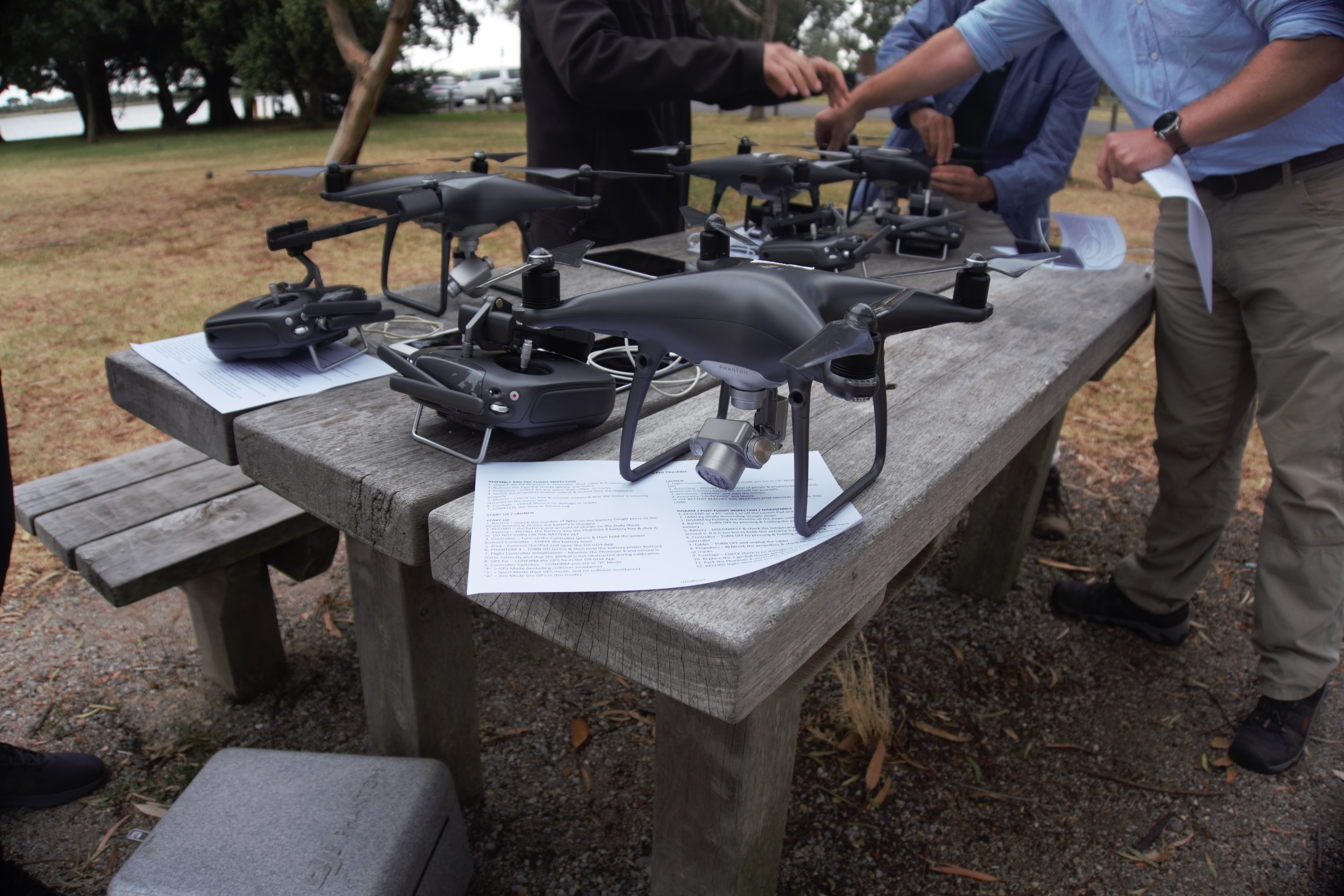 Citizen scientists around table with drones