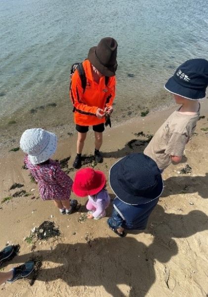 A group of children on a beach.