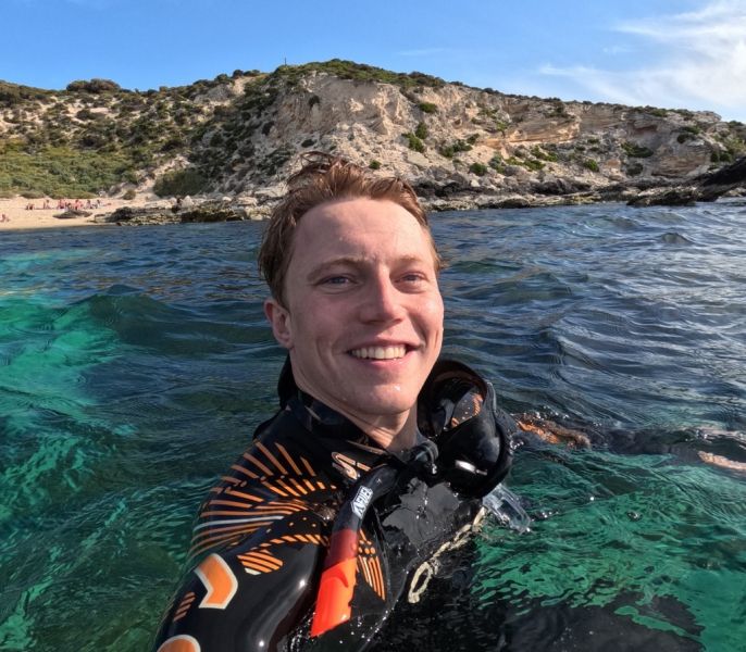 A person in a wetsuit in the water.